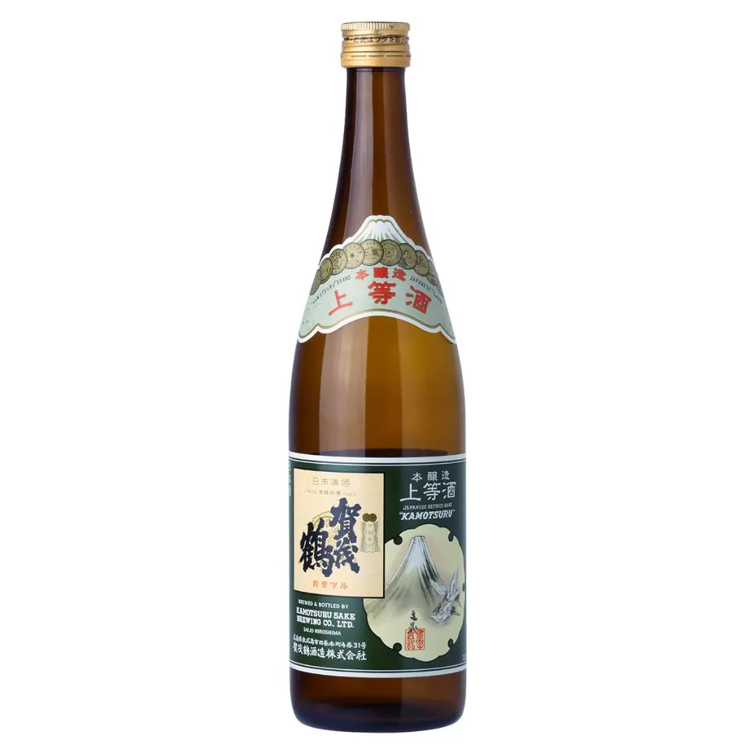 A bottle of JP SAKE (KAMOTSURU JOUTOUSHU) with a label featuring traditional Japanese art and text, indicating it is a special edition table sake.